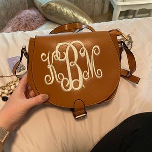 Monogrammed “leather” crossbody